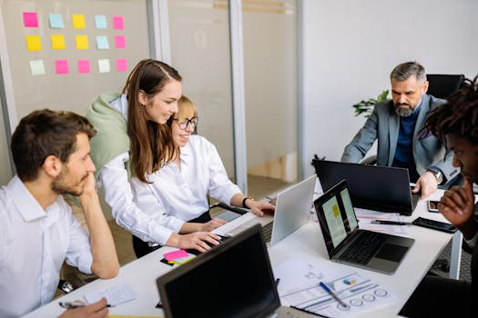 Diverse team of business professionals collaborating in a modern office setting.